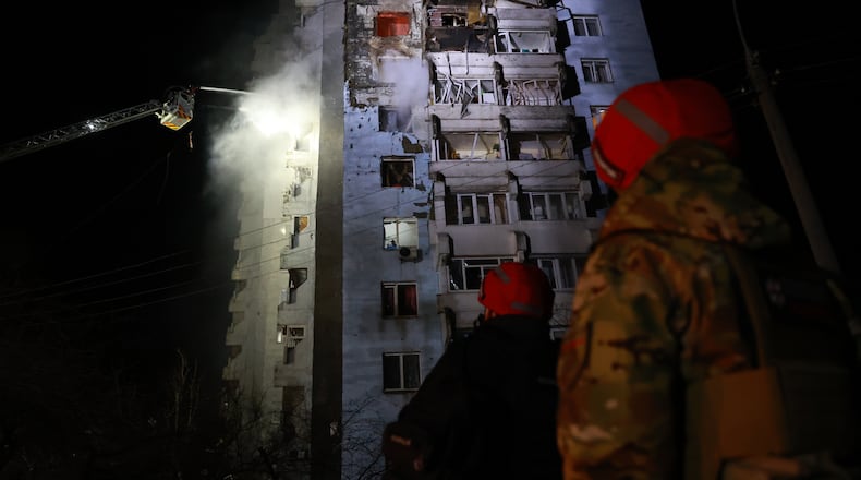 Rescue workers try to put out a fire of a residential building burning after a Russian drone attack on Zaporizhzhia, Ukraine, Tuesday, March 24, 2026. (AP Photo/Kateryna Klochko)