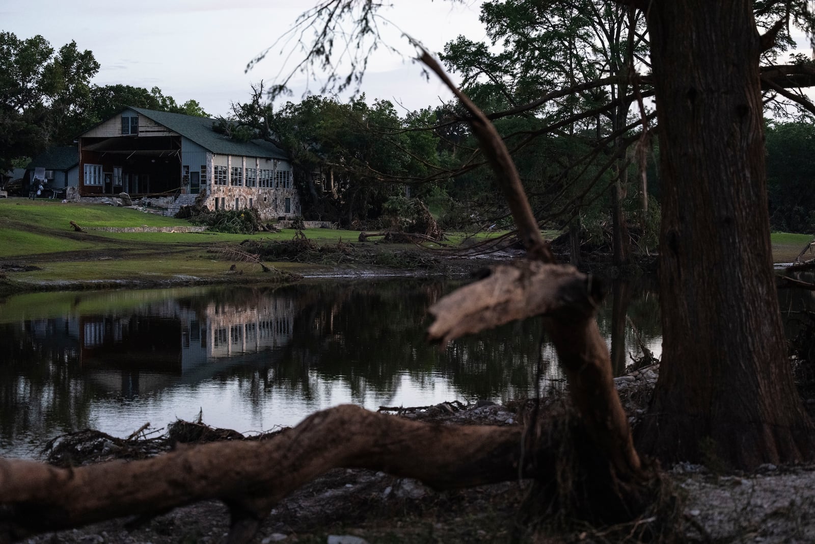 FILE - Camp Mystic is reflected in water after a flash flood swept through the area July 7, 2025, in Hunt, Texas. (AP Photo/Eli Hartman, File)