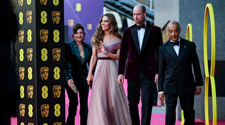 Britain's Prince William and Kate, Princess of Wales arrive with Jane Millichip, CEO of the British Academy of Film and Television Arts and Lord-Lieutenant of Greater London Ken Olisa to the 79th British Academy Film Awards, at the Royal Festival Hall, in London, Sunday Feb. 22, 2026. (Jaimi Joy/Pool Photo via AP)