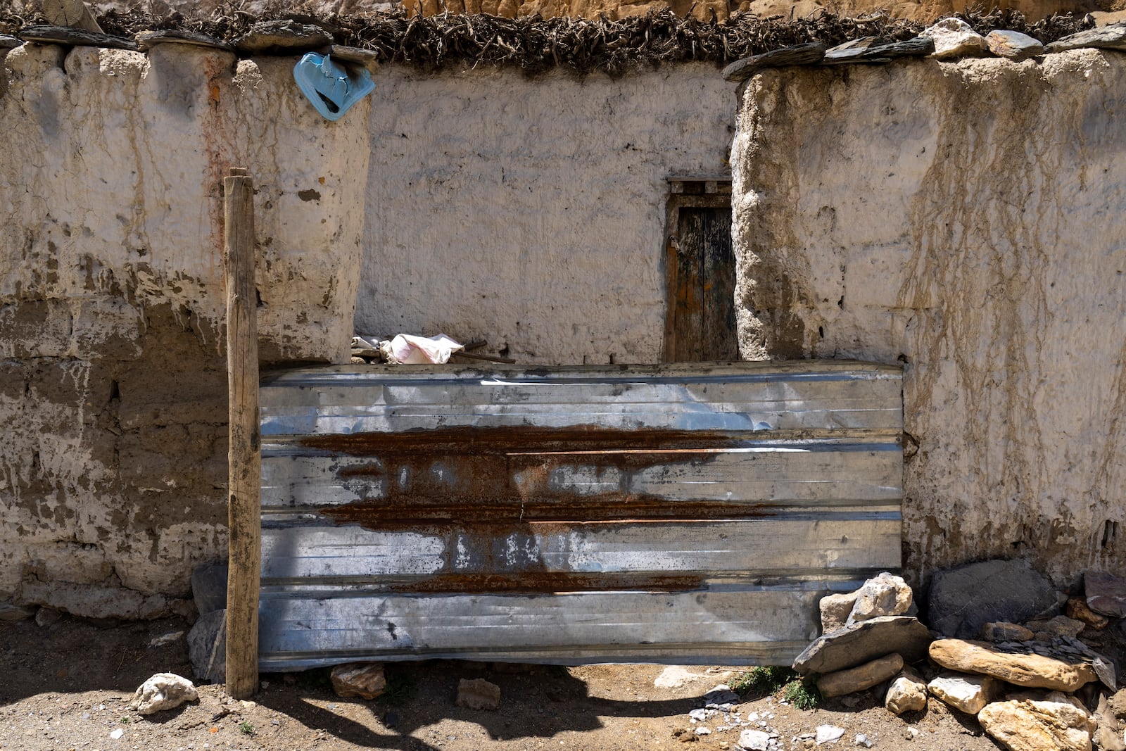 The locked door of a house is seen ain the abandoned village of Samjung, Mustang region, 462 kilometers west of Kathmandu, Nepal, Friday, April 18, 2025. (AP Photo/Niranjan Shrestha)