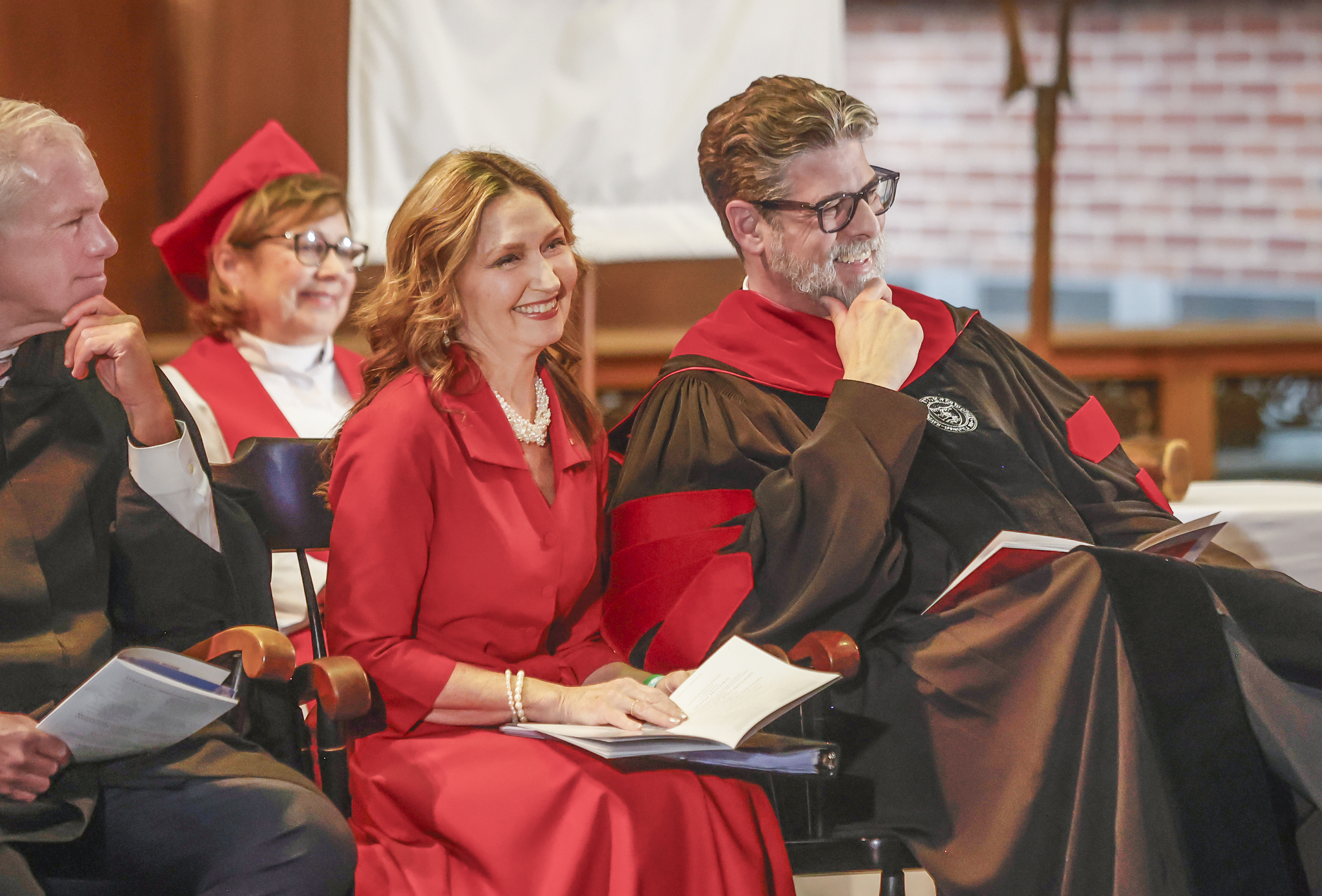 Elizabeth Brady, left, and her husband Dr. Christian M.M. Brady laugh at a joke as he gets acknowledged during his inauguration on Friday, October 17, 2025, at Wittenberg University's Weaver Chapel. JOSEPH COOKE/STAFF