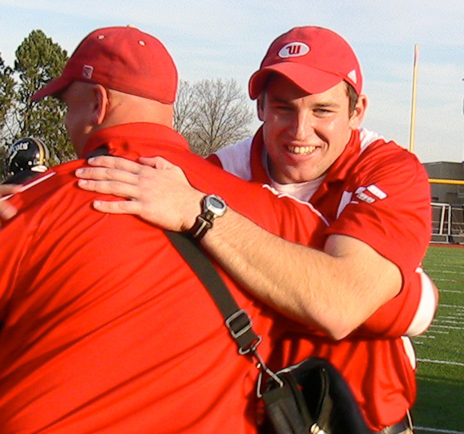 Wittenberg assistant coaches B.J. Coad, right, and Tom Mescher hug after the Tigers beat Wooster 22-17 on Saturday at John P. Papp Stadium. Staff photo by David Jablonski