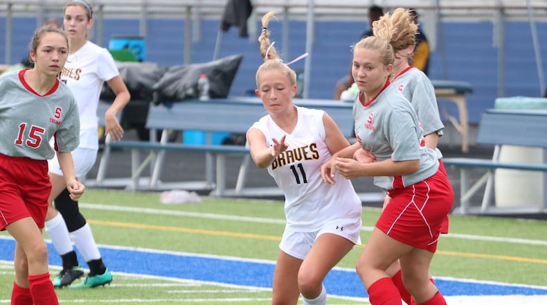 Shawnee High School senior Lena Jenssen (11) dribbles the ball through the Southeastern defense during the first annual Clark County Soccer Preview on Aug. 12 at Evans Stadium in Springfield. Jenssen is the top returning scorer in the Central Buckeye Conference this season, tallying 71 points last season. MICHAEL COOPER / CONTRIBUTED