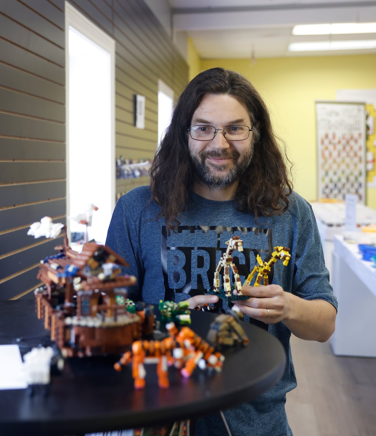Dan Jacob looks at giraffe and penguin Legos in his store on Monday, June 2, 2025, at Brick Base. JOSEPH COOKE/STAFF