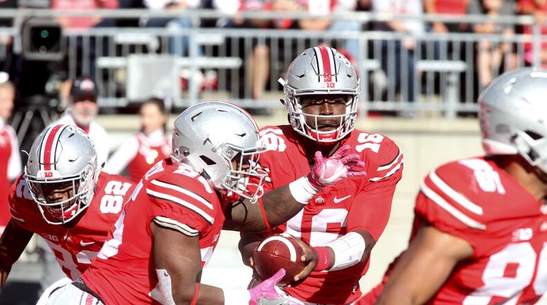Ohio State's J.T. Barrett hands off to Mike Weber against Indiana on Saturday, Oct. 8, 2016, at Ohio Stadium in Columbus. David Jablonski/Staff