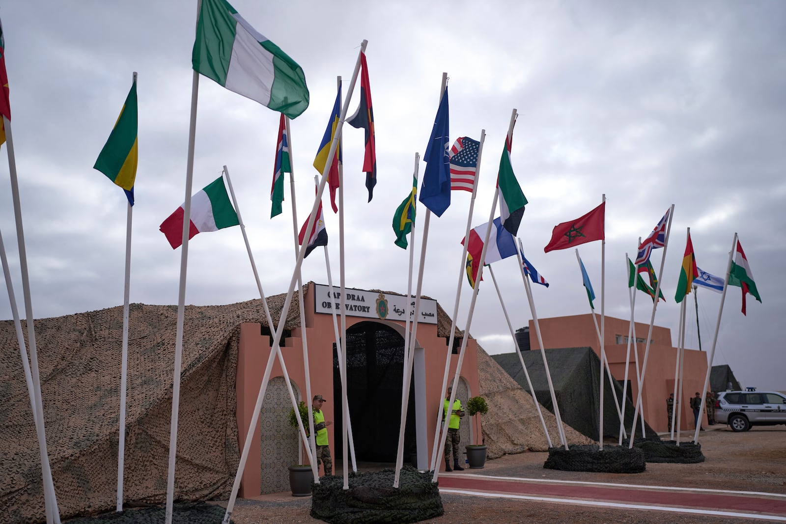 Flags of participating countries are placed outside an observatory during 21st edition of the African Lion military exercise, in Tantan, south of Agadir, Morocco, Friday, May 23, 2025. (AP Photo/Mosa'ab Elshamy)