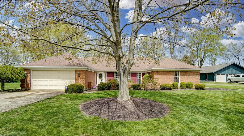 The 3-bedroom, brick ranch home offers about 2,090 sq. ft. of living space. The front of the home has a courtyard with brick wall surround, mature trees and attached, 2-car garage. CONTRIBUTED PHOTO