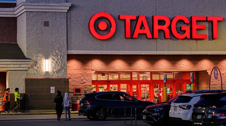 Shoppers walk towards a Target retail store, Tuesday, Nov. 18, 2025, in Salem, N.H. (AP Photo/Charles Krupa)
