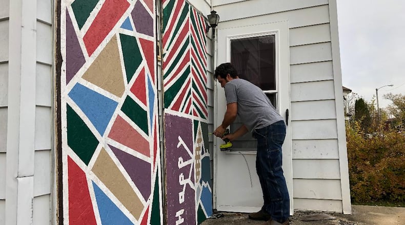 Velorossa Design owners Nate and Mandie Fleming saw an opportunity to improve abandoned Springfield properties by painting door and window panels to lessen the blight. Photo by Brett Turner