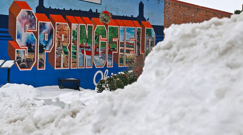 Snow is piled up in front the Greetings from Springfield mural along South Fountain Avenue Tuesday, Jan. 7, 2025. BILL LACKEY/STAFF