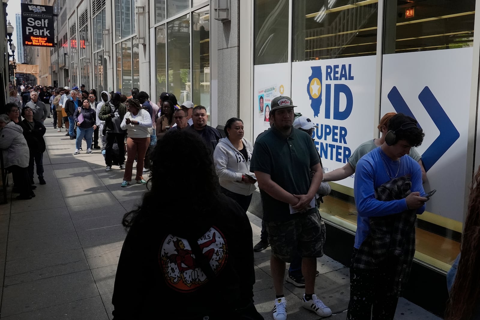 People line up to apply for Real ID at a Real ID Supercenter in downtown Chicago, Tuesday, May 6, 2025. (AP Photo/Kiichiro Sato)