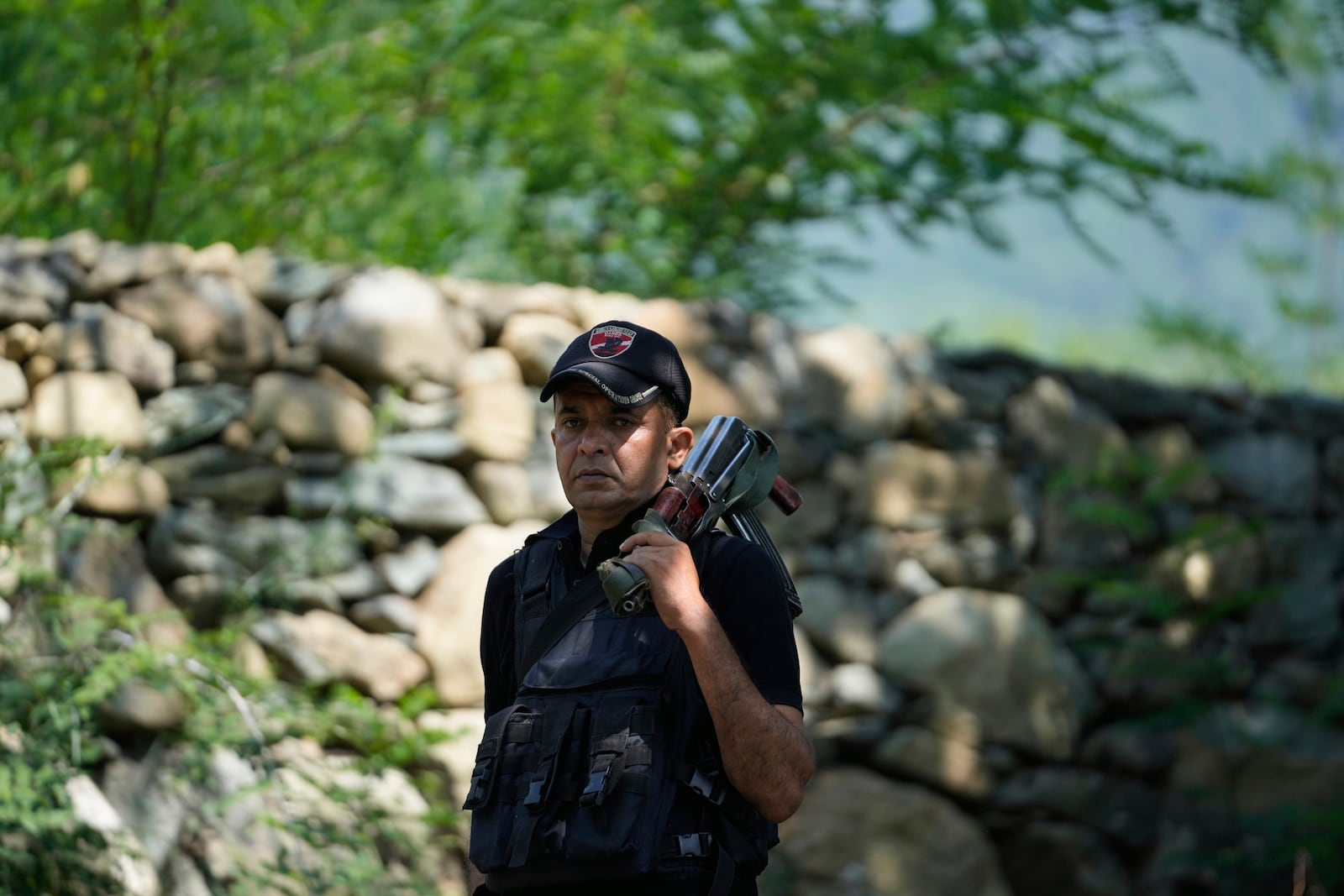 Jammu and Kashmir Special Operation Group (SOG) personnel guard near the site of a gun battle on the outskirts of Srinagar, Indian controlled Kashmir, Monday, July 28, 2025. (AP Photo/Mukhtar Khan)
