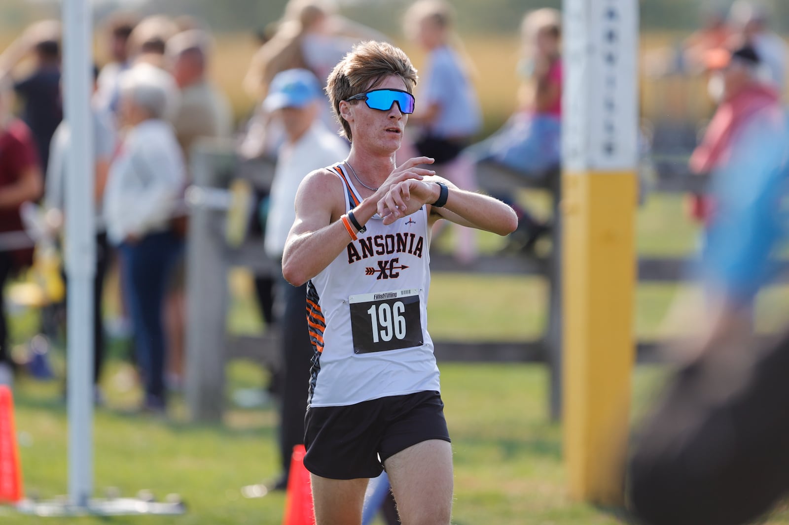 Ansonia High School junior  Bennett Lehman checks his watch after crossing the finish line at the Division III district cross country meet held Saturday, Oct. 18 at Cedarville University. Lehman took first in a time of 15:55. MICHAEL COOPER / STAFF