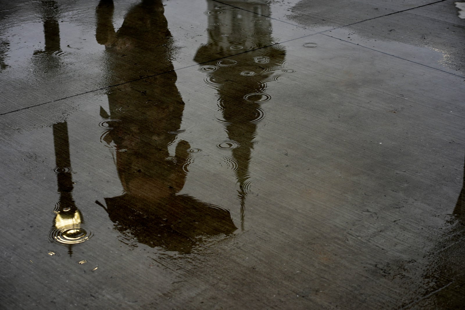 A race fan walks in the rain at Churchill Downs before the 151st running of the Kentucky Derby horse race Saturday, May 3, 2025, in Louisville, Ky. (AP Photo/Charlie Riedel)