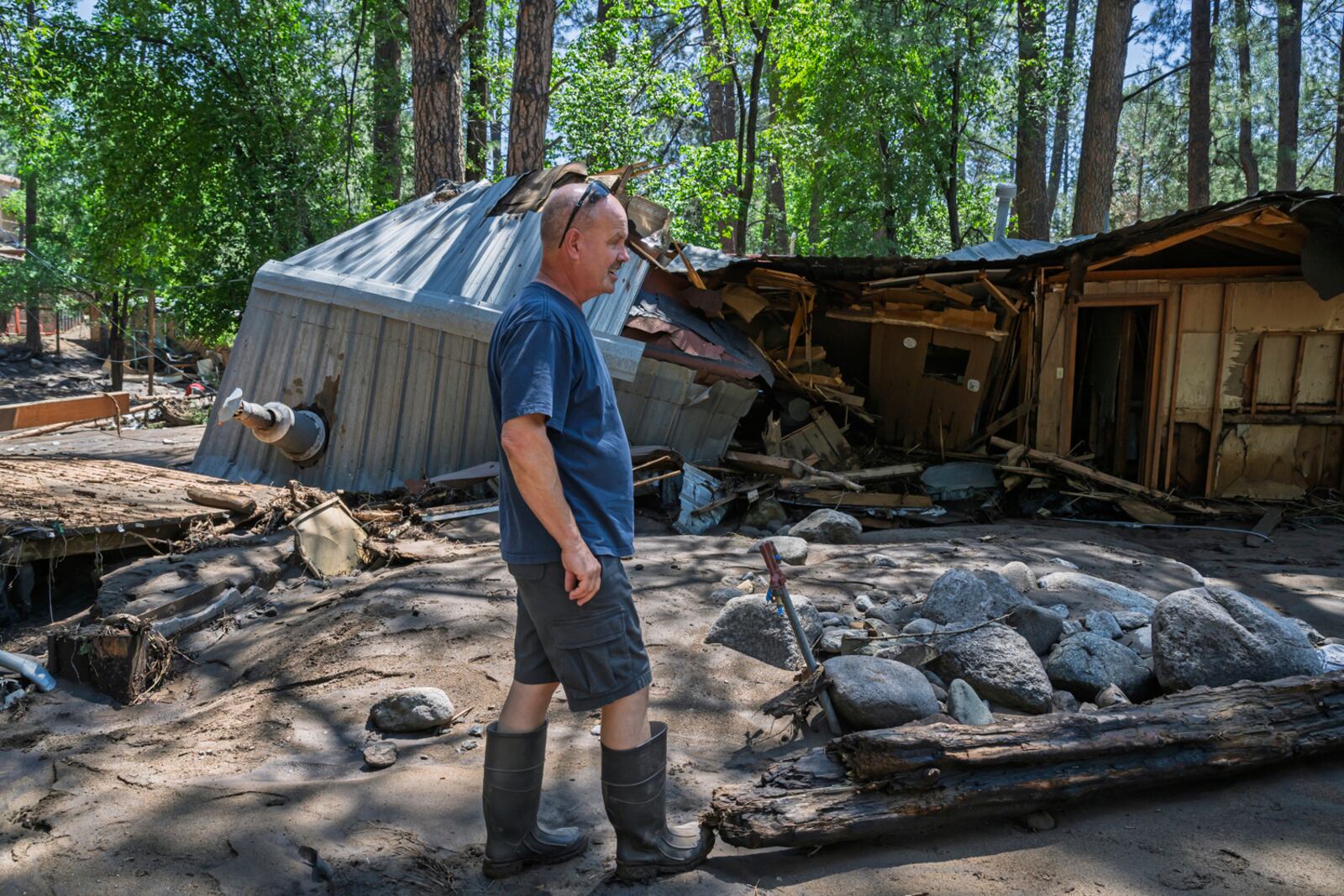 Dan Privett stands on what would be the front of his house, Wednesday, July 9, 2025, in Ruidoso, N.M., which was destroyed in the flash floods yesterday that hit the town. (AP Photo/Roberto E. Rosales)
