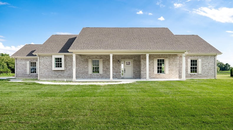 The front of the home features a covered porch with concrete floor and pillars and an all-brick exterior. Contributed photos