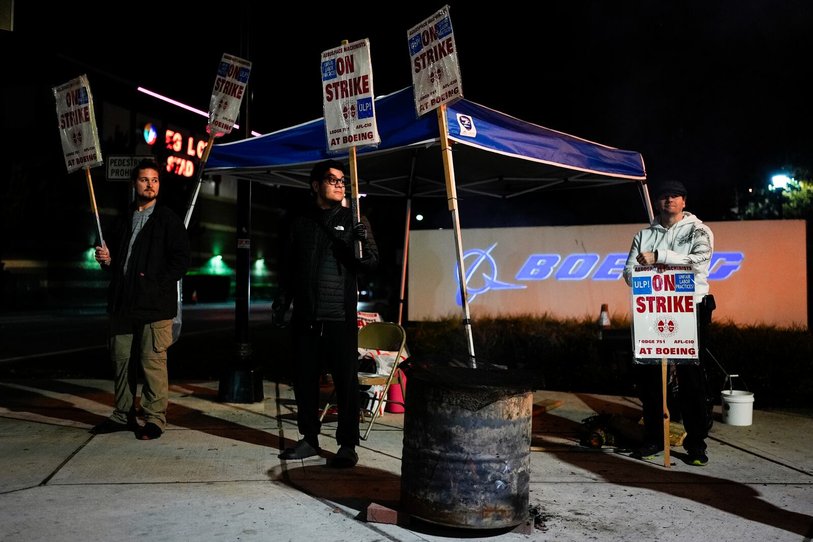 FILE - From left, Boeing employees Vance Meyring, Josue Ramirez and Joseph Mellon work the picket line after union members voted to reject a new contract offer from the company, Wednesday, Oct. 23, 2024, outside Boeing facilities in Renton, Wash. (AP Photo/Lindsey Wasson, File)