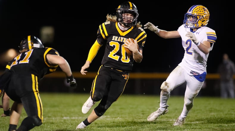Shawnee High School junior Tyler Mercer runs past a Mariemont defender during their game on Saturday night in the Springfield. The Braves on 21-7 to advance to a regional final game for the first time since 2011. Michael Cooper/CONTRIBUTED