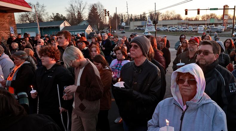 People fill the parking lot of Gill's Quality Meat Market Monday, Jan. 9, 2023 during a candle light vigil for Thomas Gill, who was shot and killed in January while driving his SUV in Springfield. BILL LACKEY/STAFF