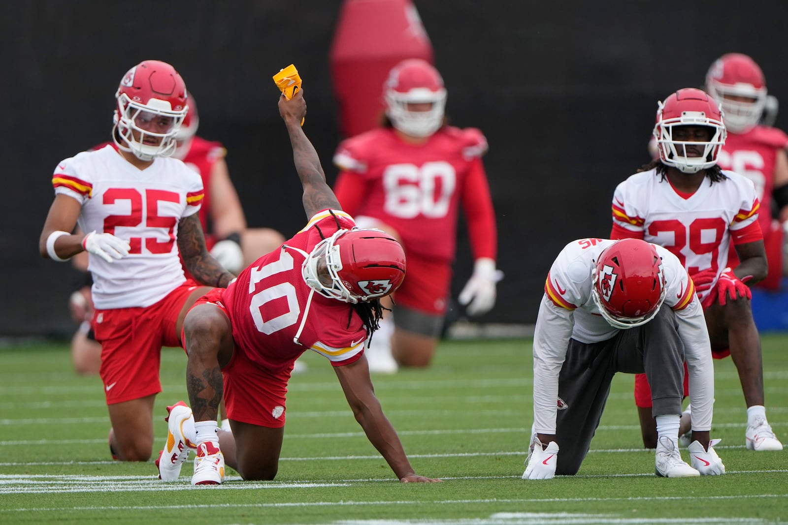 Kansas City Chiefs running back Isiah Pacheco (10) stretches with teammates during the NFL football team's practice Tuesday, June 17, 2025, in Kansas City, Mo. (AP Photo/Charlie Riedel)