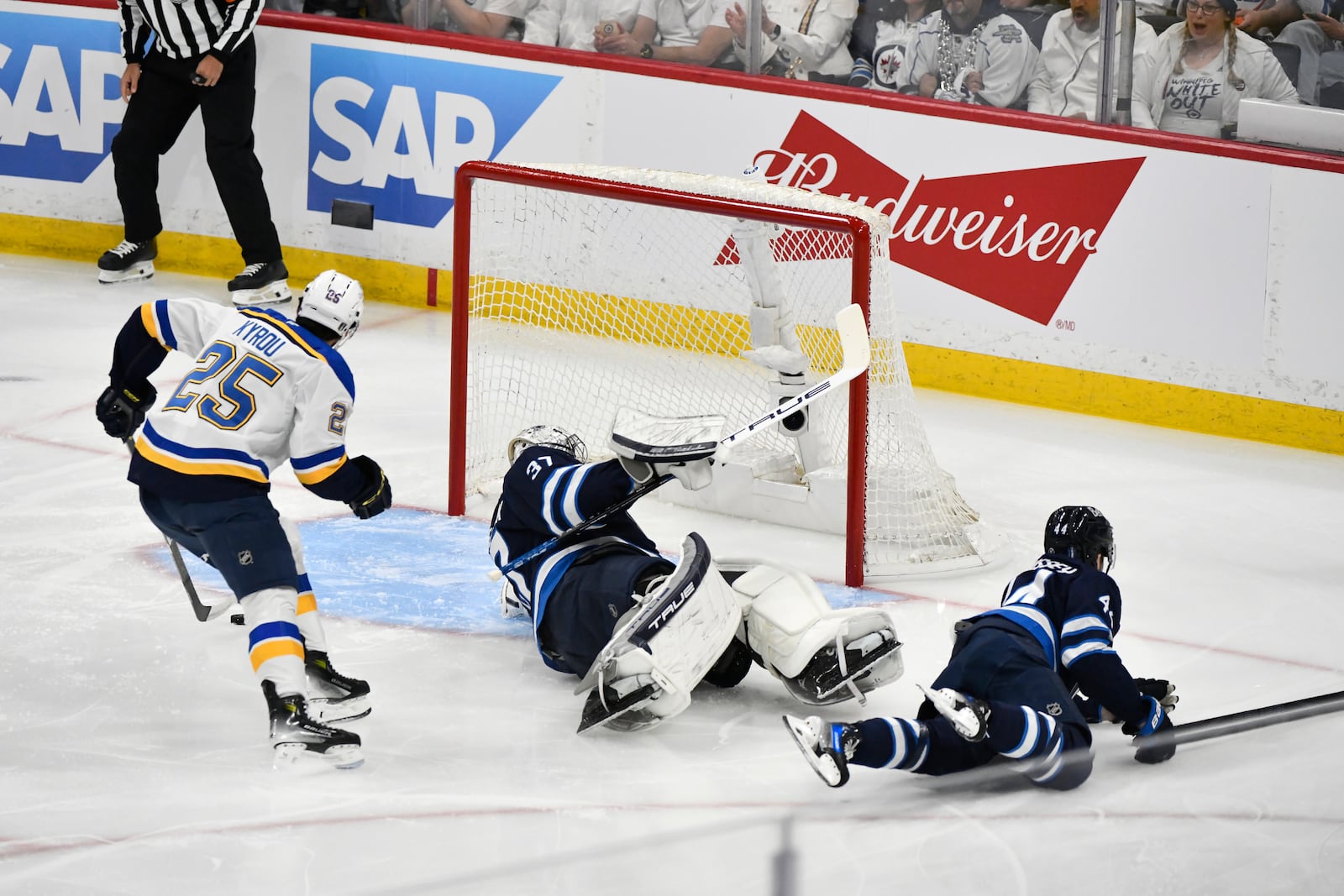 St. Louis Blues' Jordan Kyrou (25) scores against Winnipeg Jets' goaltender Connor Hellebuyck (37) during the first period of Game 7 in an NHL hockey first-round playoff series in Winnipeg, Manitoba, Sunday, May 4, 2025. (Fred Greenslade/The Canadian Press via AP)