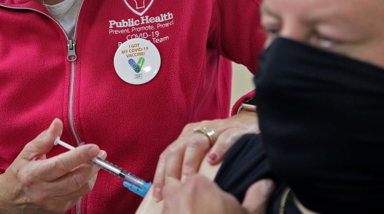 Dale Briggs gets his COVID vaccine booster shot at the Clark County Combined Health District's vaccine center. BILL LACKEY/STAFF