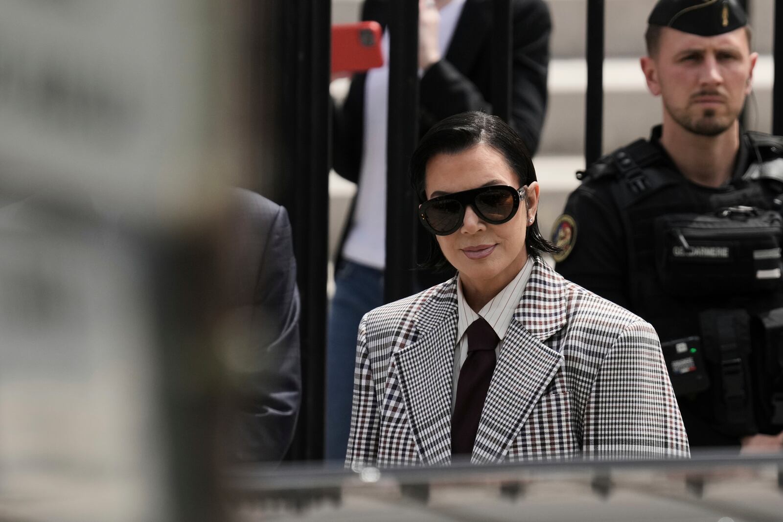 Kris Jenner, center, the mother of Kim Kardashian, arrives for a trial regarding a robbery of millions of dollars in jewels from Kim Kardashian's Paris hotel room in 2016, in Paris, Tuesday, May 13, 2025. (AP Photo/Aurelien Morissard)