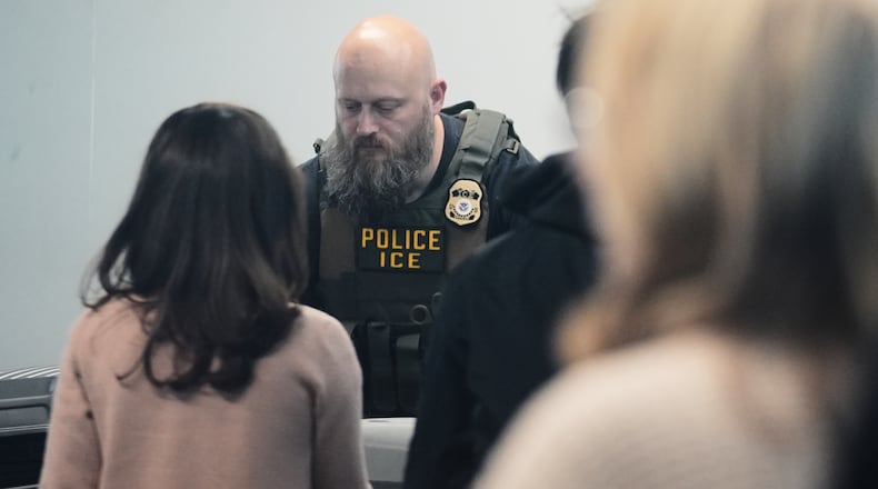 An Immigration and Customs Enforcement (ICE) agent works at the baggage check at O'Hare International Airport in Chicago, Tuesday, March 24, 2026. (AP Photo/Nam Y. Huh)