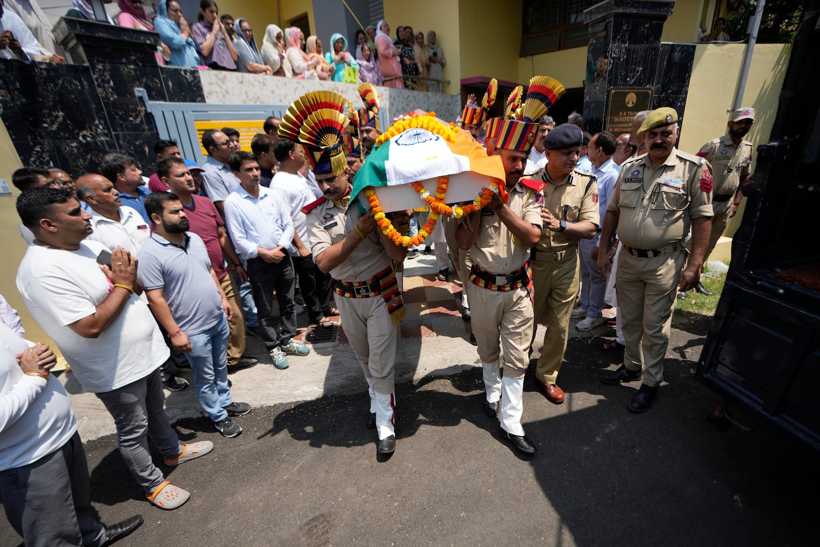 Police personnel carry the casket containing the body of Raj Thapa, a senior bureaucrat who was killed in Pakistani shelling in Rajouri, at his funeral in Jammu, India, Sunday, May 11, 2025. (AP Photo/Channi Anand)