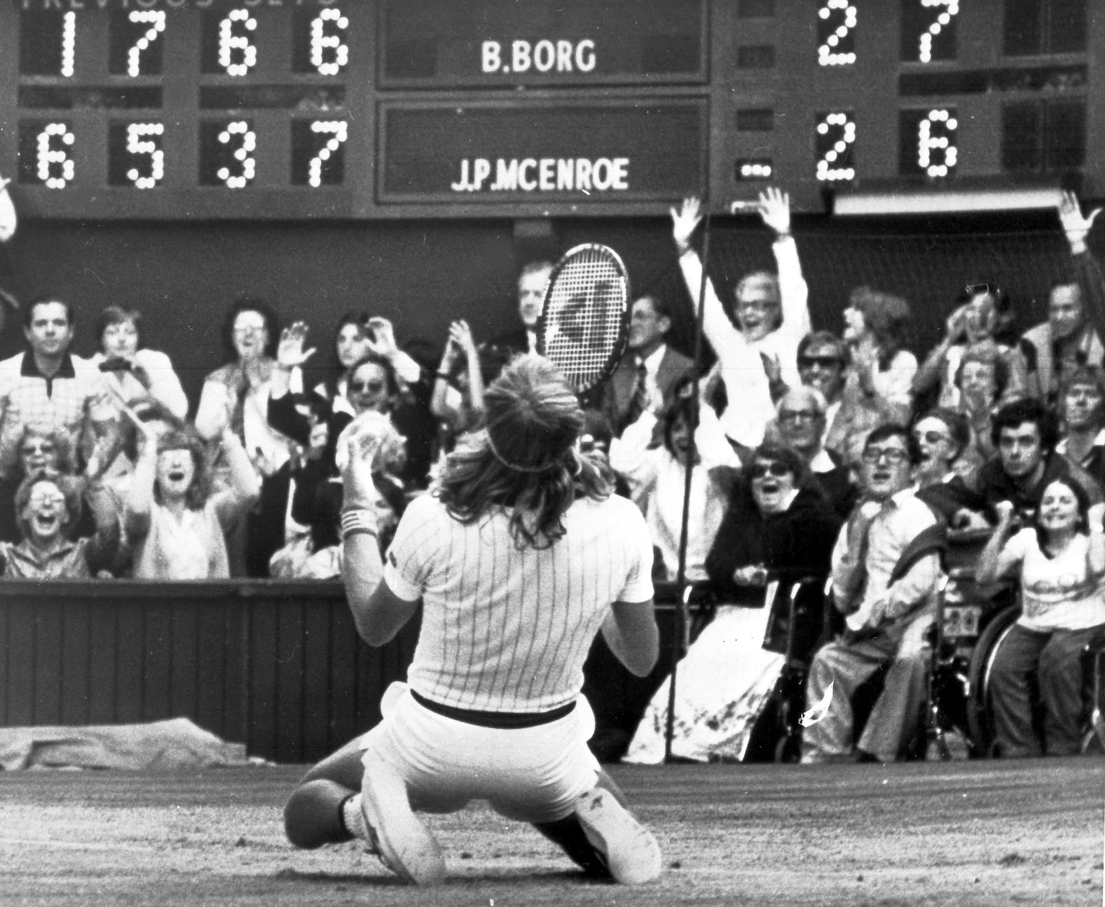 FILE - Sweden's Bjorn Borg falls to his knees in front of the scoreboard on the Centre Court, Wimbledon, London, July 5, 1980, after beating American John McEnroe, unseen, 1-6, 6-3, 7-5, 6-7, 8-6, to take the Mens' Singles Final for the fifth year in succession. (AP Photo/Robert Dear)