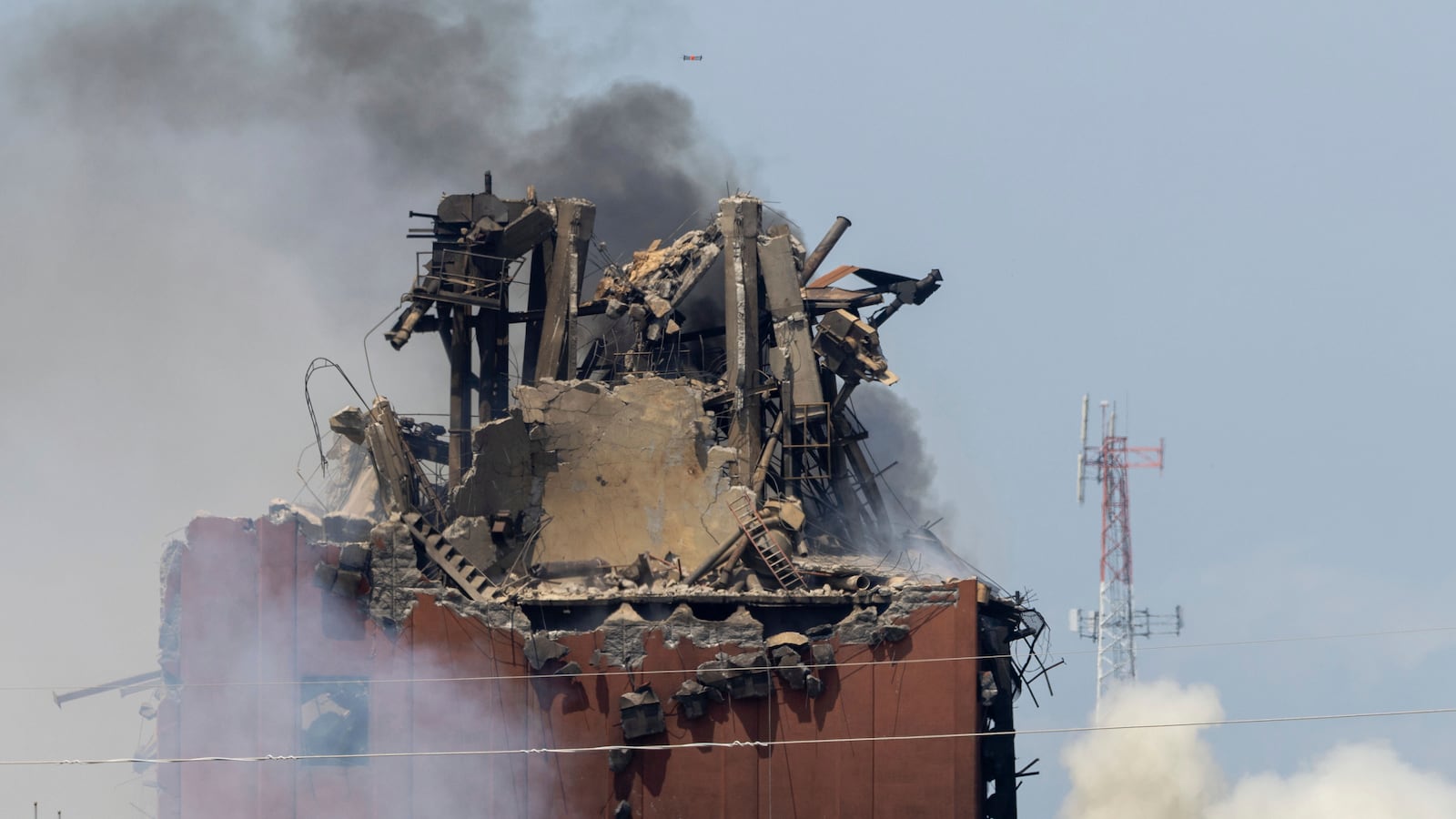 A drone is seen above as firefighters battle a fire after an explosion in an industrial area in Fremont, Neb., Tuesday, July 29, 2025. (Chris Machian/Omaha World-Herald via AP)