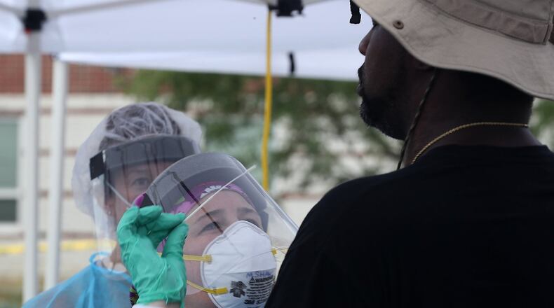 A man gets a COVID-19 test Wednesday at the Clark County Combined Health District’s free COVID testing clinic. BILL LACKEY/STAFF