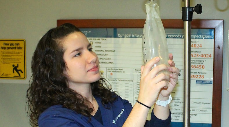 Jeanee Kizer a registered nurse at Springfield Regional Medical Center gets an IV bag ready for use. JEFF GUERINI/STAFF