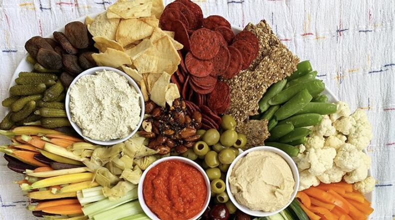 FILE: A charcuterie board is literally the easiest thing to throw together and, when done right, makes a gorgeous and delectable centerpiece. Pick 3 different kinds of cheese, three different meats, grab some figs, a handful of grapes, a few rosemary sprigs and you are in business. CONTRIBUTED BY KAITLIN SKILKEN