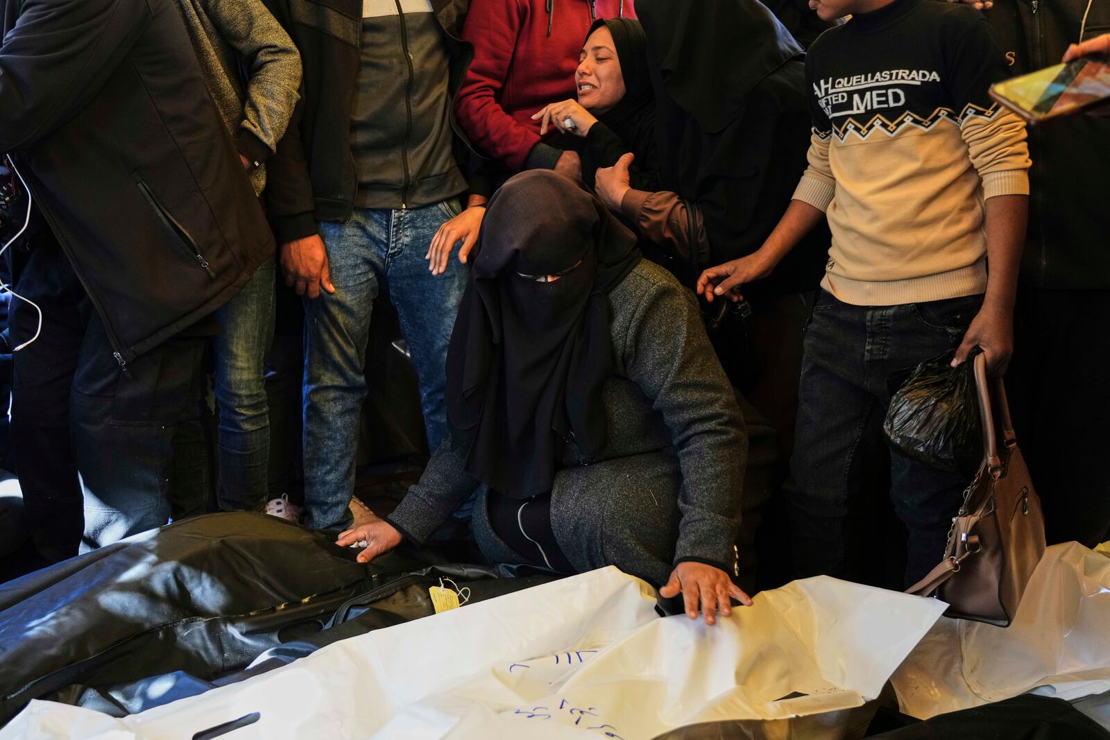 Relatives Mourn over the bodies of 10 members of the Abu Al-Rous family, killed when an Israeli airstrike struck their displacement tent overnight, during their funeral in Khan Younis, southern Gaza Strip, Thursday, April 17, 2025. (AP Photo/Abdel Kareem Hana)