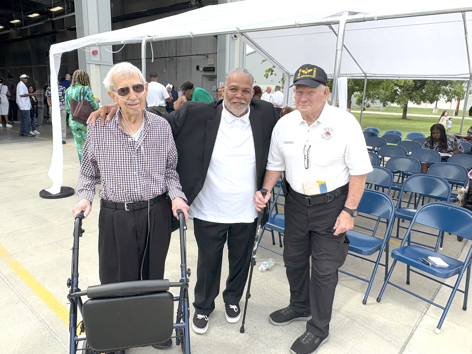 Steve Ross (center) — the son of former Wright Patterson  Air Force Base assistant fire chief Bill Ross, the first African American firefighter ever at the base — at  Saturday’s dedication ceremony. He’s flanked by two former firefighters who worked with his dad at the base. On the left is 88-year-old Neil Mangan who worked 33 years with the department and retired as Chief in 1996. On the right is 70 year old Randy Hawkins who was with the department for 35 years. Both men had high praise for Ross as a firefighter and as a man. TOM ARCHDEACON / CONTRIBUTED PHOTO