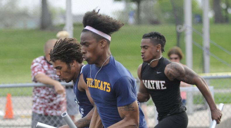 Springfield’s Quincy Scott (closest) overtakes Fairmont’s Marquis Williams (left) and Diante Lesperence of Wayne during a record-setting 4x100 relay. The GWOC track and field championships were at Troy’s Memorial Stadium on Friday, May 11, 2018. MARC PENDLETON / STAFF