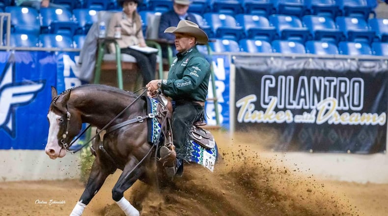 Clark County resident Shawn Flarida is shown doing the slide maneuver in a horse show. Flarida, owner of Shawn Flarida Reiners in Springfield, has earned $8 million competing with reining horses, having won every major event in the industry. CHELSEA SCHNEIDER MEDIA