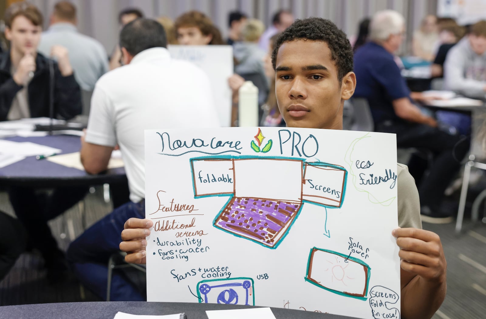 Luis Romero, a sophomore at Graham High School, shows a poster his group made during an interactive activity at Discovery Day on Tuesday, September 30, 2025, at the Hollenbeck Bayley Center. JOSEPH COOKE/STAFF