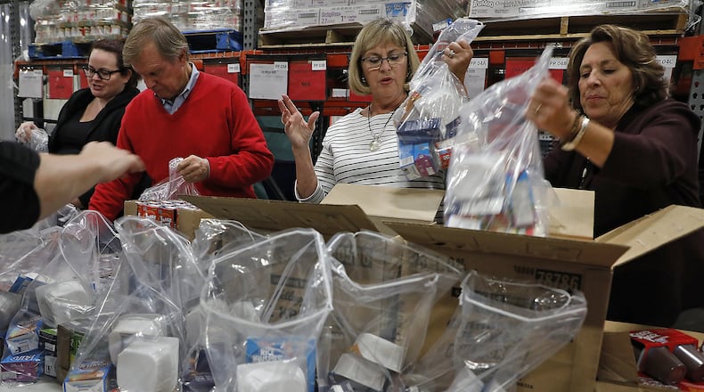 Members of the Springfield Rotary Club packaged hundreds of Power Pack food bags for Fulton Elementary Wednesday at the Second Harvest Food Bank. Bill Lackey/Staff