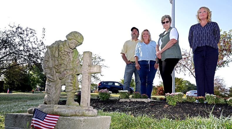 Posing for a picture at the Soldier's Mound at St. Bernard Cemetery are, from left, Wayne Woodruff and his wife, Trusie, the caretakers of the cemetery, Theresa Silvers, FCC Military Group Leader, and Betsy Van Hoose, Wreaths Across America Springfield Coordinator. BILL LACKEY/STAFF