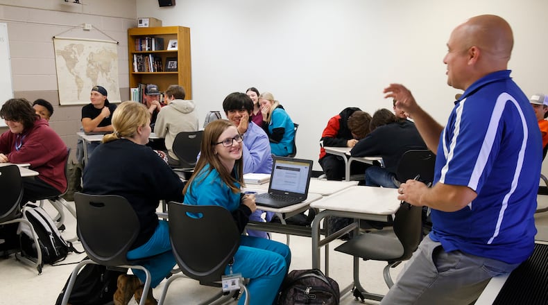 Christian Davoli teaches a Government class in a crowded classroom at the Springfield-Clark Career Technology Center.  BILL LACKEY/STAFF
