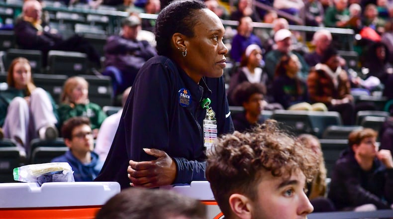 Wright State men's basketball athletic trainer LaShaunta' Jones (left) leans on a Gatorade jug during their game against Northern Kentucky on Feb. 21, 2025 at the Nutter Center. JOSEPH R. CRAVEN / CONTRIBUTED PHOTO