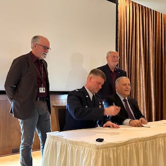 An outgrant license is signed Tuesday, Feb. 17, 2026 for work leading to what advocates hope will be a new STEM Talent Development Complex near the National Museum of the U.S. Air Force. Standing are (left) Joe Sciabica, who leaders the Employers Workforce Coalition, and retired Air Force Lt. Gen. Dick Reynolds, co-founder of Air Camp. Seated are (left) Col. Dustin Richards, 88th Air Base Wing commander and Vince Russo, Air Camp co-founder. THOMAS GNAU/STAFF