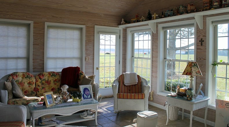 The 4-season sun room is lined with windows