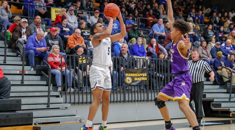 Springfield High School's Josh Tolliver shoots a 3-pointer over Vandalia Butler's Matthew Beverly during their game at Centerville High School last season. Tolliver is the Wildcats' top returning scorer this winter. Michael Cooper/CONTRIBUTED