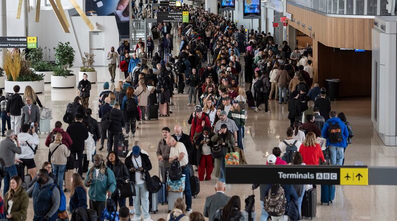 Travelers wait in a TSA line, Wednesday, March 25, 2026, at LaGuardia Airport in New York. (AP Photo/Yuki Iwamura)