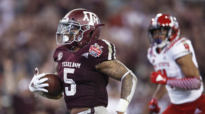 JACKSONVILLE, FL - DECEMBER 31: Trayveon Williams #5 of the Texas A&M Aggies runs for a 17-yard touchdown against the North Carolina State Wolfpack in the third quarter of the TaxSlayer Gator Bowl at TIAA Bank Field on December 31, 2018 in Jacksonville, Florida. Texas A&M won 52-13. (Photo by Joe Robbins/Getty Images)