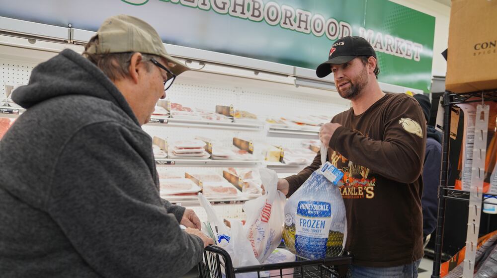 Ryan Sprankle, right, owner of the family-run grocery store Sprankle's Neighborhood Market, helps Timothy A. Mohney choose a turkey at the store Monday, Nov. 10, 2025, in Kittanning, Pa. (AP Photo/Jessie Wardarski)