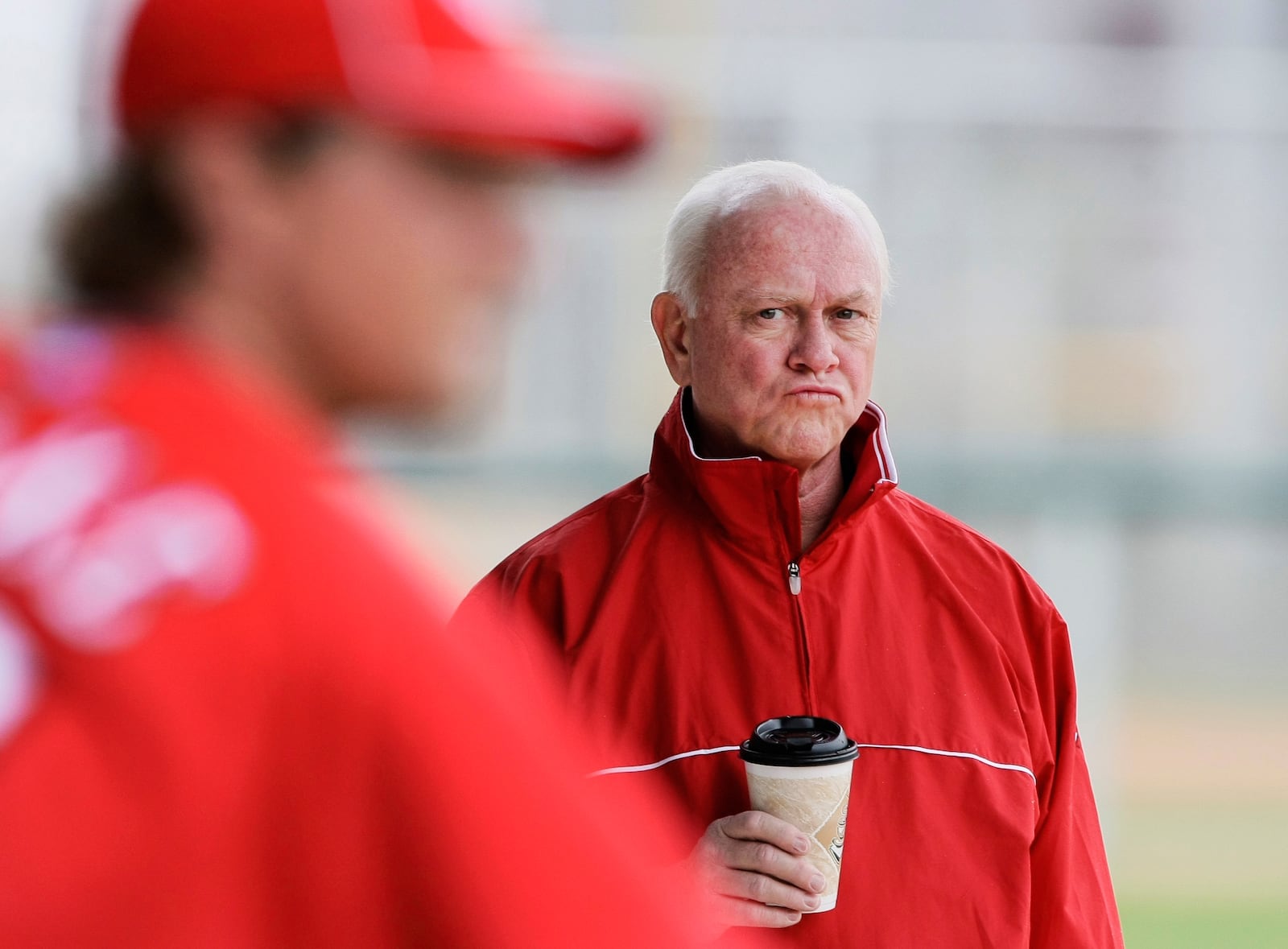 FILE - Cincinnati Reds general manager Walt Jocketty watches his pitchers work out at baseball spring training camp Saturday, Feb. 20, 2010, in Goodyear, Ariz. (AP Photo/Mark Duncan, File)